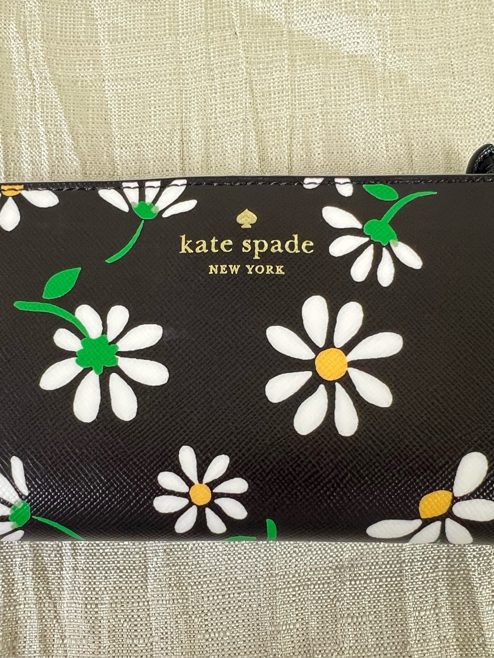 kate spade black wallet with white daisy print and green accents